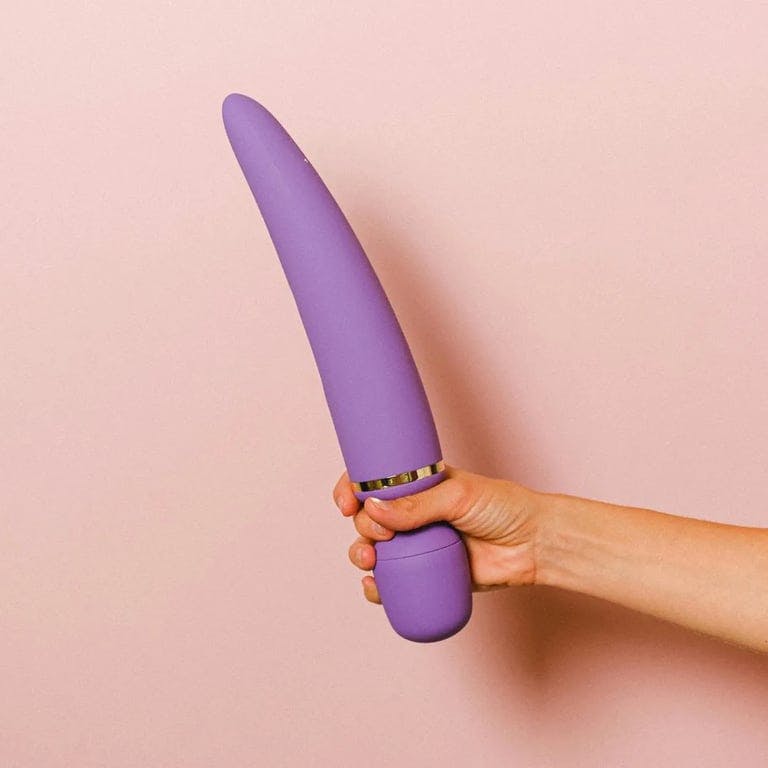 person holding purple wand vibrator